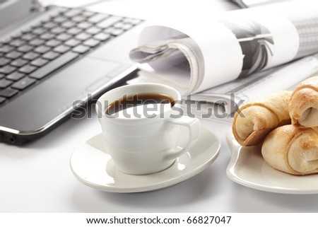 Cup of fragrant coffee on a morning paper business news