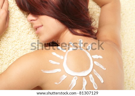 woman with sun-shaped sun cream