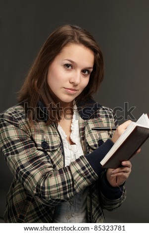 beautiful young woman with notebook