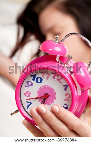 beautiful woman sleeping and alarm clock