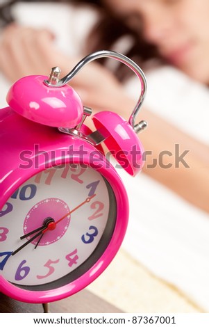 beautiful woman sleeping and alarm clock