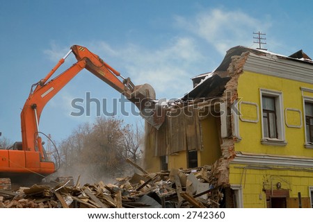 Demolition of an old house with power shovel