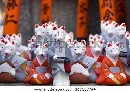 Little fox statues at Fushimi Inari Shrine in Kyoto, Japan