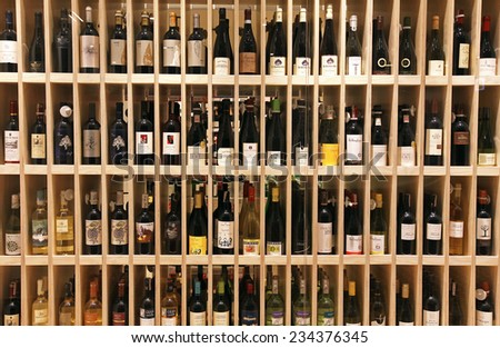 VILNIUS, LITHUANIA - OCTOBER 5, 2013: Variety of wine bottles on wooden shelf in wine store in Vilnius, Lithuania