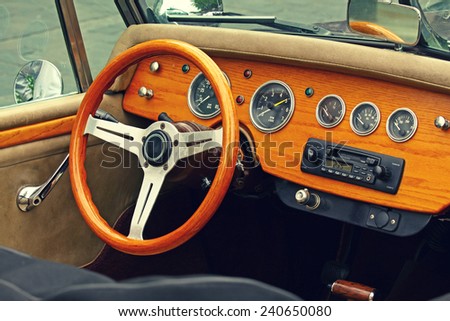 Wooden interior of antique luxury car. Retro feel photographic effect