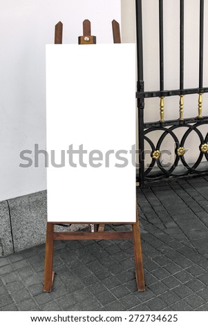 Picture of blank wooden placard, standing on the street, ready to put any text