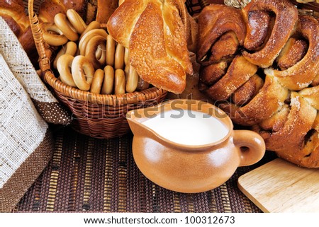 milk in a mug buns and appetizing rolls