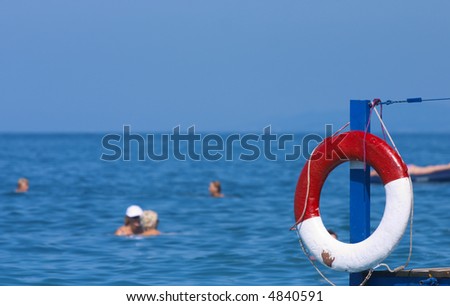 white-red rescue circle of ship on a background a blue sea and sky