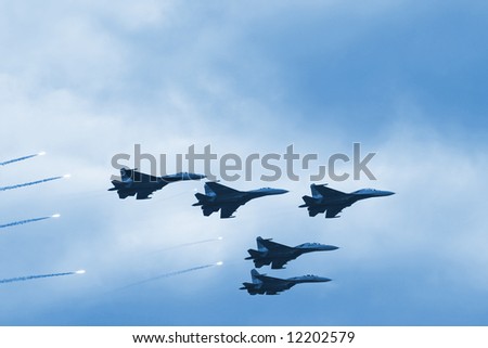 Modern squadron of military planes shooting rockets