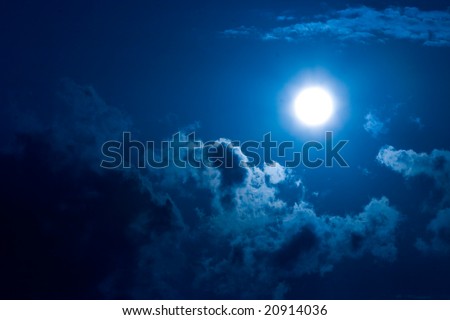 Shone circle of the moon in darkness on a background of the star sky and clouds