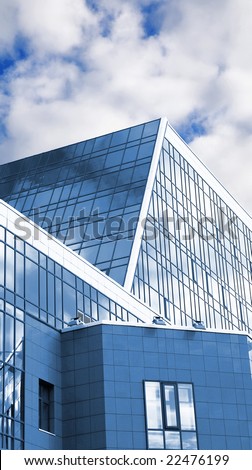 Architectural details of a modern building of business type on a background of the cloudy sky