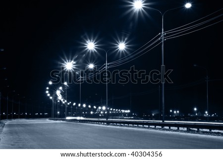 Night urban street with lights from lanterns