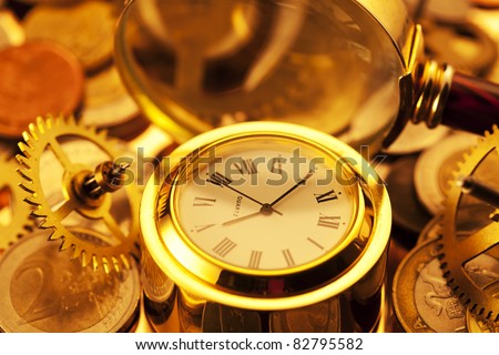 gold watches, coins, gears and magnifying glass