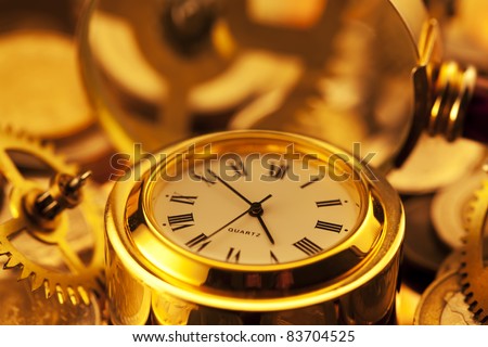 gold watches, coins, gears and magnifying glass