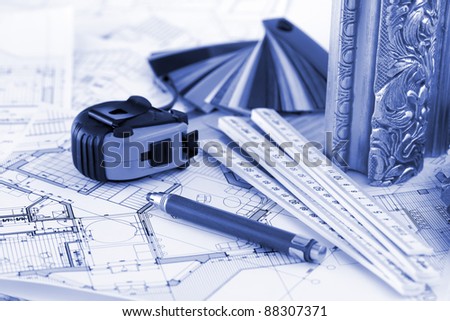 samples of architectural materials - plastics,  metric folding ruler, tape measure, pencil & architectural drawings of the modern house