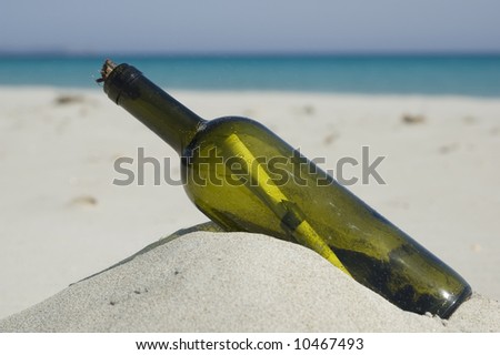 Old bottle with a message inside. Blue sea background. Beach scenic