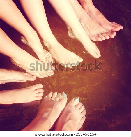 fun istagram of family feet in water splashing with effect