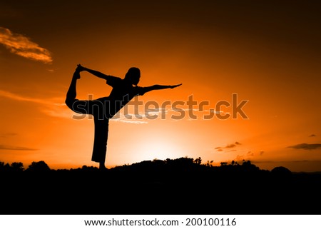 silhouette of women yoga with sunset in holiday