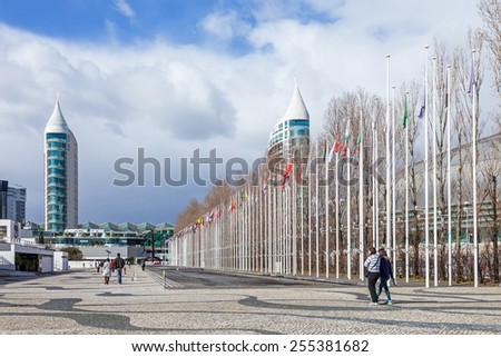 Lisbon, Portugal - February 01, 2015: Flags of all countries of the world in Rossio dos Olivais (Olive Grove Square). Parque das Nacoes (Park of Nations). Sao Gabriel Tower and Vasco da Gama Mall