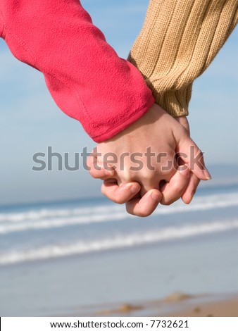 holding hands on beach
