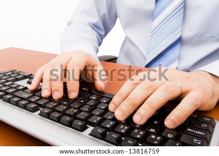 Man typing in the computer keyboard