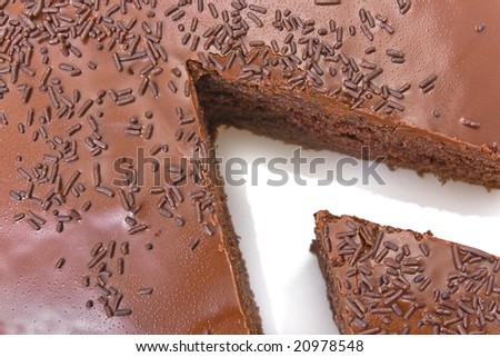 Sliced chocolate fudge cake isolated on white background