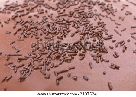 Detail of the topping of a Chocolate fudge cake with sprinkles