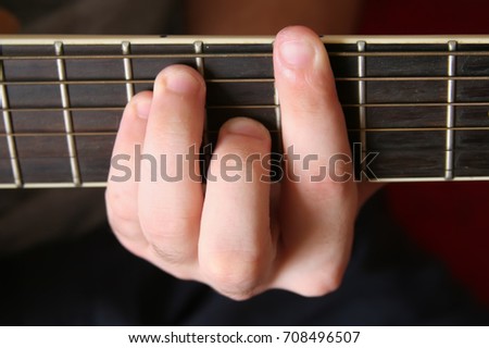 man plays the classical six-string guitar