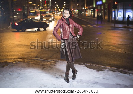 Lady in winter night city blurred background