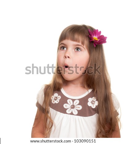 cute little girl very surprised and looking up somewhere with bud of chrysanthemum in hair against white background