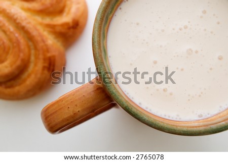 traditional breakfast of cup of sour milk and golden bun