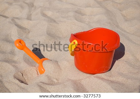 orange toy shovel and red bucket