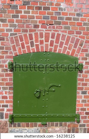 old steel stronghold security door  in brick wall