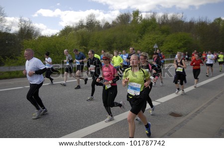 FREDERICIA, DENMARK - MAY 5: Runners on the road after 11,5 km in Little Belt Half Marathon run, Kystvejen in Fredericia, Denmark. May 5, 2012