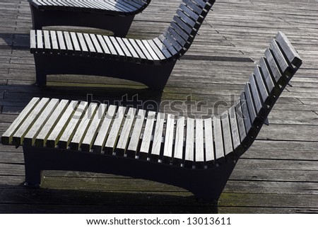 Wooden chairs on wooden pier a sunny day