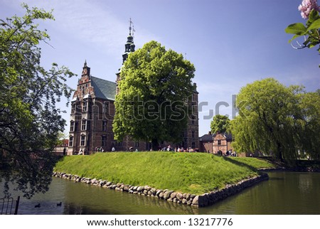 People round Royal Rosenborg Castle in Copenhagen, Denmark – Danish Crown Jewels are kept here. The castle was originally built as a country summerhouse – Year 1606.
