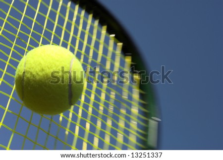 Ball and Racket - Tennis racket and yellow tennis ball sky blue