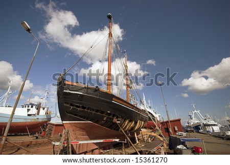 Make Ready. Danish fishing port with old wooden fishing boat on land a sunny day in Denmark