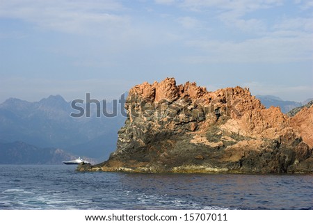 Mountain and Luxury Boat. Mediterranean Sea, Wake, Boat  and Corsican Mountain Rocks. Coastline outside Porto, Corse-Du-Sud, Corsica, France