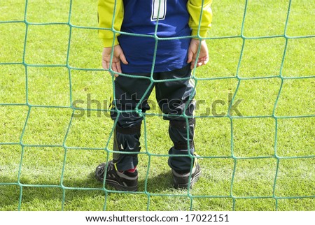 Just on the line. Young football goalkeeper with number one just on the goal line.
