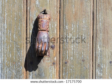 Vintage door knocker on an old Corsican wooden door