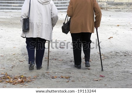 Autumn Walk. Two women in the 70s walking in a park in Paris