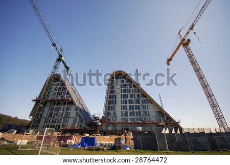 VEJLE, DENMARK - APRIL 19: The Wave Residence building site and nearby football field. Designed by Henning Larsen and being built at the shoreline of Vejle Fjord. April 19 2009, Denmark.