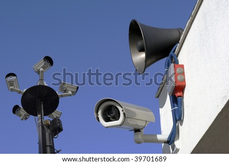Big Brother watching. Surveillance cameras and loudspeakers outside on building.
