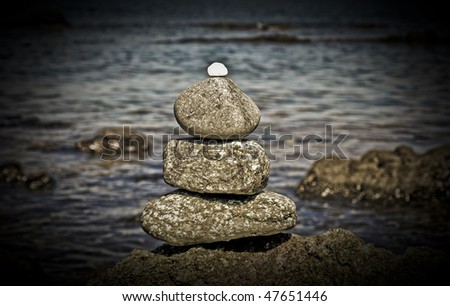 Rocks in balance on rocky beach close to the sea.