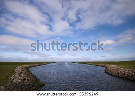 Ribe River outside the dike. The Wadden Sea National Park. View from lock in Ribe dike.