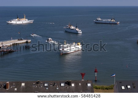 Ferry service close to Helgoland. Small boats carry passengers to bigger boats.