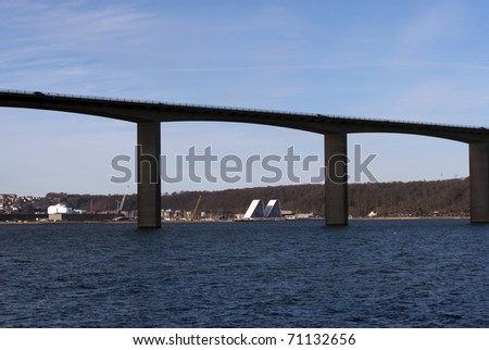 Vejle fjord in Denmark with bridge and town skyline.
