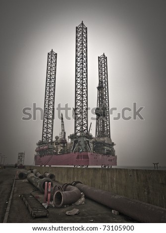 Oil rig close to Esbjerg harbour with pipes all over. Danish platform from North Sea.