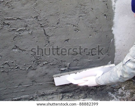 Worker at work doing indoor house repair with plaster